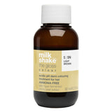 Brown bottle of milk_shake the gloss hair color treatment with a white cap on a white background