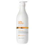 White bottle of Milk Shake moisture & more conditioner on a white background