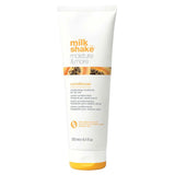 250ml Tube of milk_shake moisture & more conditioner on a white background