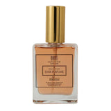 La Beaute Haute Couture Parfume -  Transparent tube with gold liquid on a white background