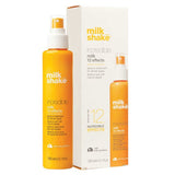 Orange bottle and white box of Milk Shake incredible hair treatment on a white background