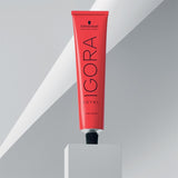 Red tube of Schwarzkopf IGORA Royal hair color on a gray background